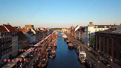 The camera takes off over the old canal of Copenhagen, Denmark. bridge in Nyhavn New Harbour canal and entertainment