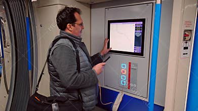 Man charging smartphone in the free USB port