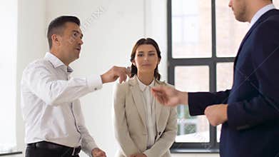 Realtor giving key to customers at new office