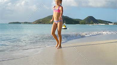 Adorable little girl have fun at tropical beach