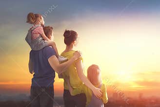 Happy family at sunset