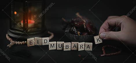 Man Arranging Eid Mubarak Greeting Scrabble Letters. Ramadan Can