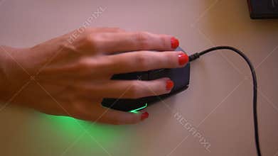 Closeup of woman`s hand holding mouse