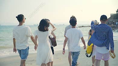 Asian adults men and women having fun walking on beach