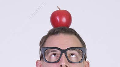 Closeup head shot of nerd man with apple on head