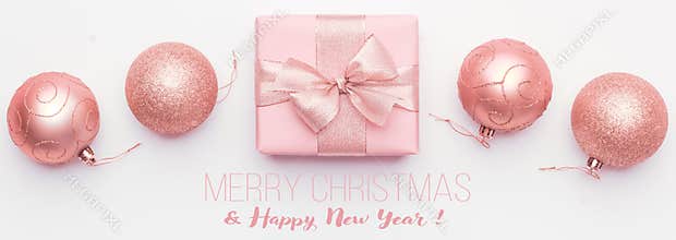 Christmas banner. Beautiful pink christmas gift and ornament baubles isolated on white background.