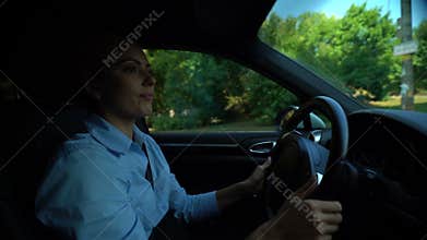 Annoyed woman looking for parking lot, attentive driver keeping to road rules