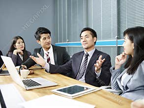 Asian business man talking at negotiation table