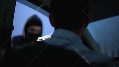 Robber stealing car, threatening victim with gun, urban criminal activity