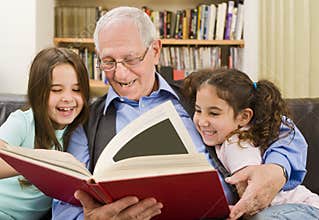 Senior and children reading
