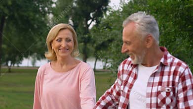Seniors all in love, happily dancing walking, enjoying romantic date slow-motion