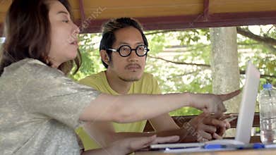 Beautiful asian Woman Shows Interesting Stuff on Her Smartphone to Her Friends