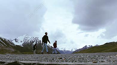 Traveler Walking On The Road In The Mountains Near Khunjerab Pass, Pakistan China Border