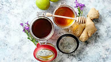 Healthy food table with different kinds of honey, fresh ginger and lime