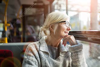 Senior Woman Traveling In Bus