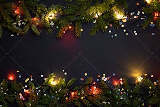 Christmas lights and decoration with fir tree and confetti