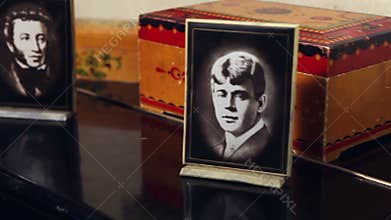 Portraits of classical Russian writers in a frame in a retro interior, black and white portraits of Pushkin and Yesenin