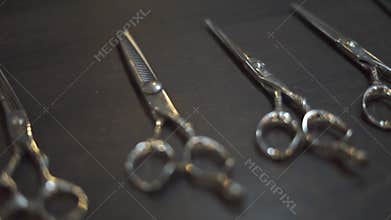Hairdressing scissors and barber accessories in hair salon close up. Professional tools for haircut in barber shop. Hair