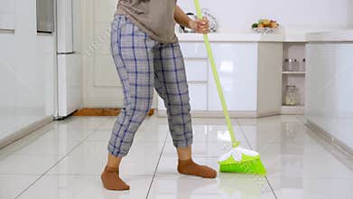 Woman feet dancing while cleaning floor
