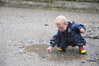 Toddler, playing in a puddle