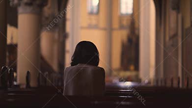 Rear view of Christian woman praying to GOD