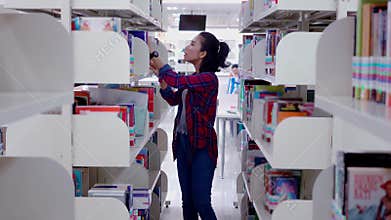 College student looking for book in library