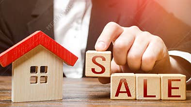 Realtor making word Sale near house. Buying and selling housing. Search for options. Affordable housing. Property appraisal.