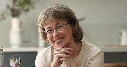 Older age female looking in camera with smile enjoying life