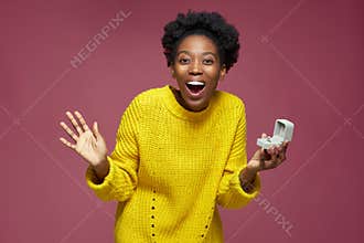 Excited happy young african american woman hold gift box with engagement ring surprised by receiving marriage proposal