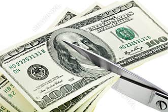 Business concept. Dollars are cutting with scissors.