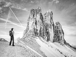 Backpacker on trip aound  Tre Cime di Lavaredo in sunny April  morning