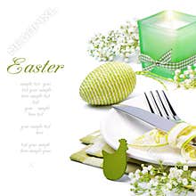Easter table setting with candle and flowers