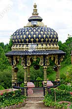 Moundsville, West Virginia, U.S.A - August 20, 2021 - A decorative gold and black pergola at Prabhhupada`s Palace of Gold