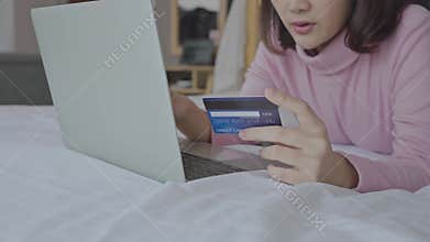 Young woman entering payment information form plastic card in cellphone application, shopping in internet store, purchasing goods