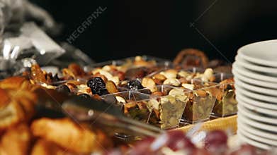 Catering service on banquet table with canape snacks in restaurant or hotel. Decorated food set with nuts and dried