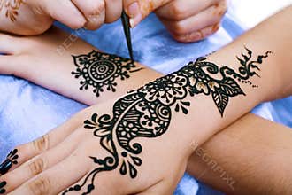 Henna being applied to hand