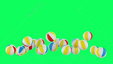 Colorful beach ball fall on green screen