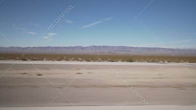 Driving plate side view moving through desert in car