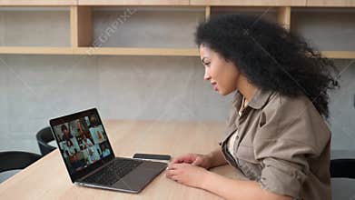 Video chat with employees. African-American woman on online meeting with many people together