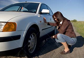 Woman changing tyre.