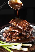 Delicious Chinese food, beef with sauce in iron pot