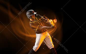 Professional baseball player in sports equipment training alone isolated on dark background with mixed light effect