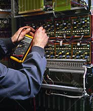 Electrician testing industrial machine