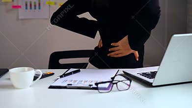Stressed business woman suffering from back pain, Office syndrome concept