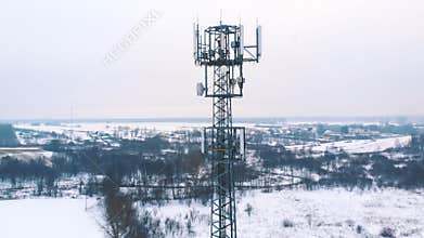 Drone orbiting around 5G antenna covered in snow.