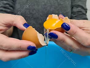 broken egg in hand