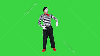 Man dressed like mime looking far away on a Green Screen, Chroma Key.
