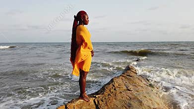 African woman standing on a beautiful beach