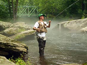 Trout Fisherman Checking his Line for Wind Knots
