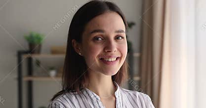 Happy attractive young 25s woman looking at camera.